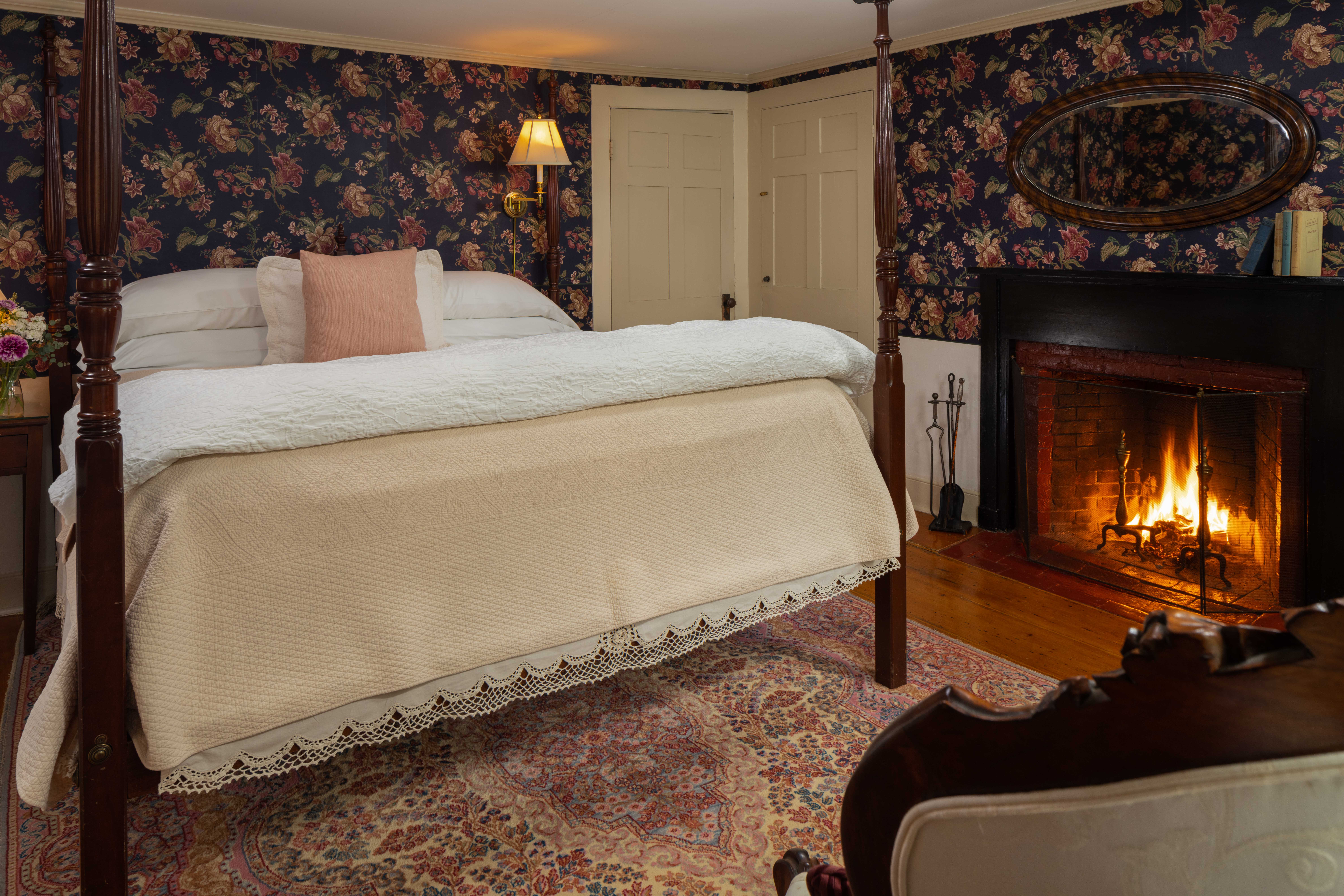 Cape House Suite with a King bed a seating area and a large fireplace