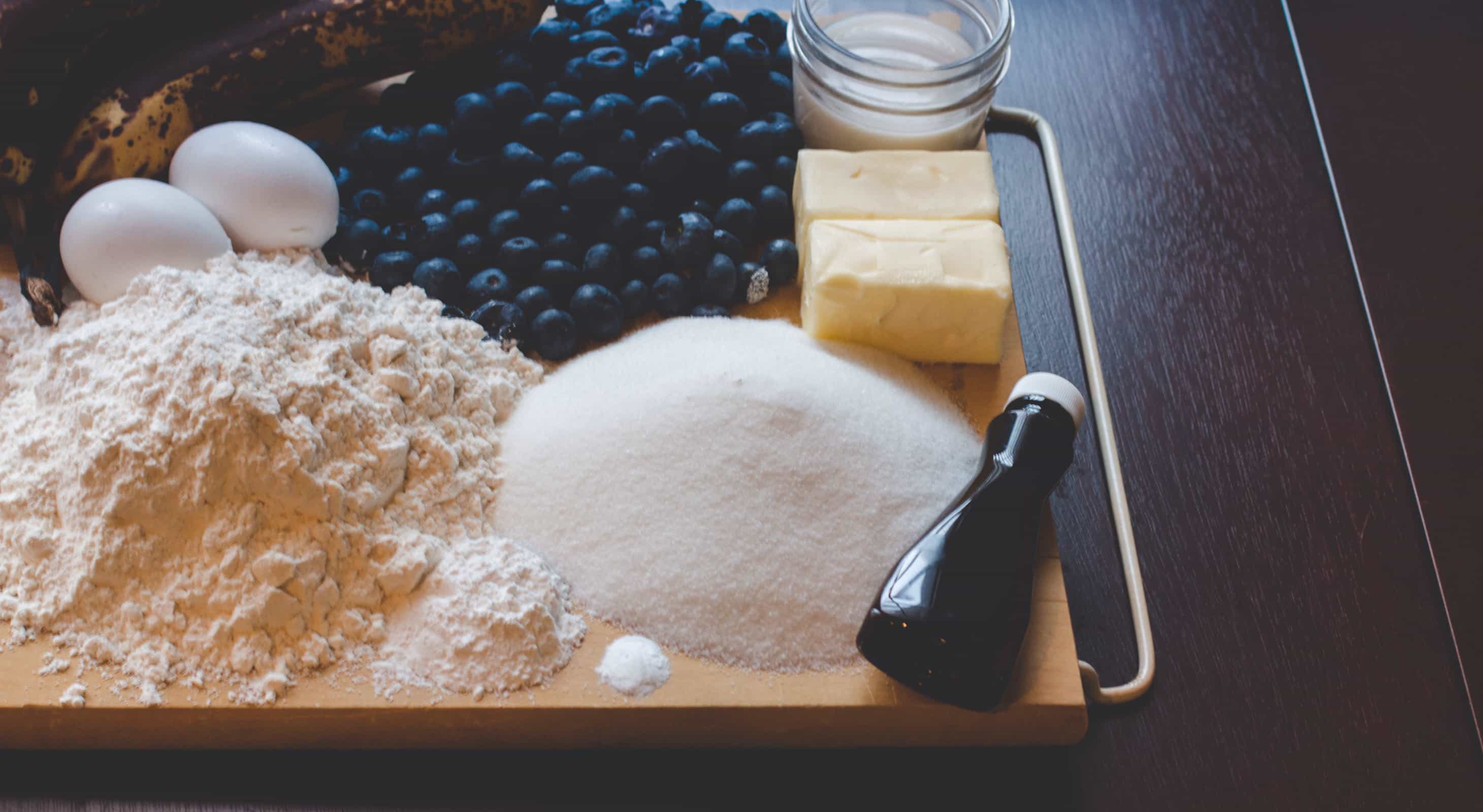 Baking ingredients and blueberries on a tray