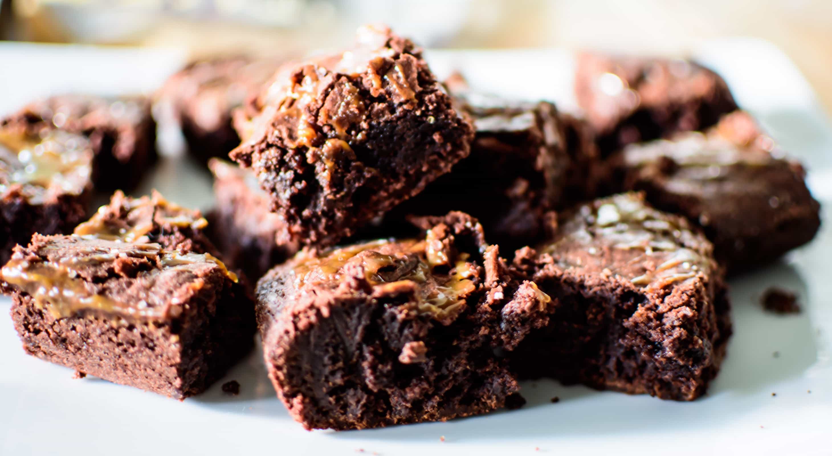 A plate of brownies with chopped nuts