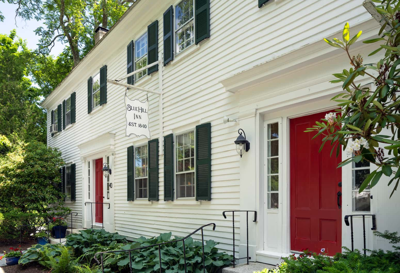 Main Inn entrance with a several steps leading to a red door