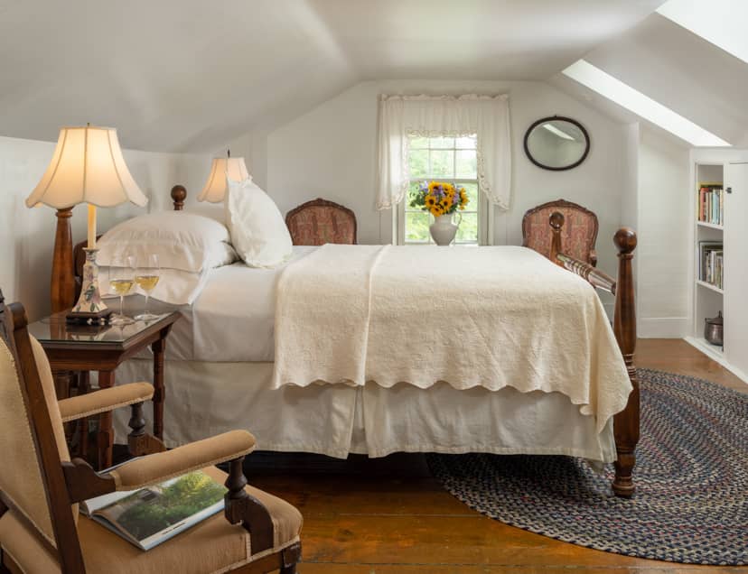 Room 9 with a queen bed in a third floor room with skylights and a seating area for two