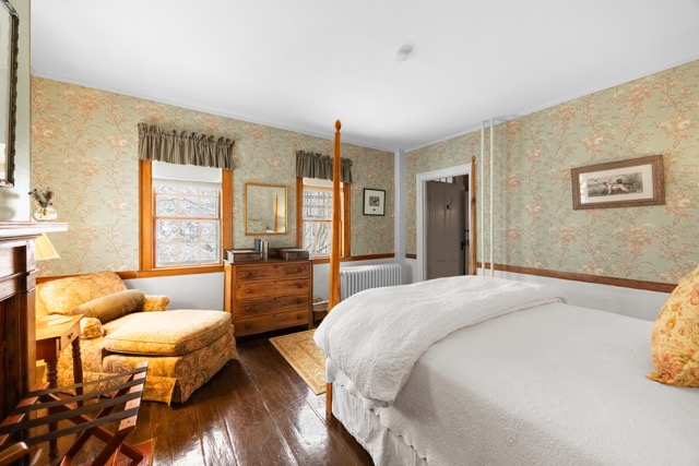 Room 11 with a king bed and a fireplace with a seating area