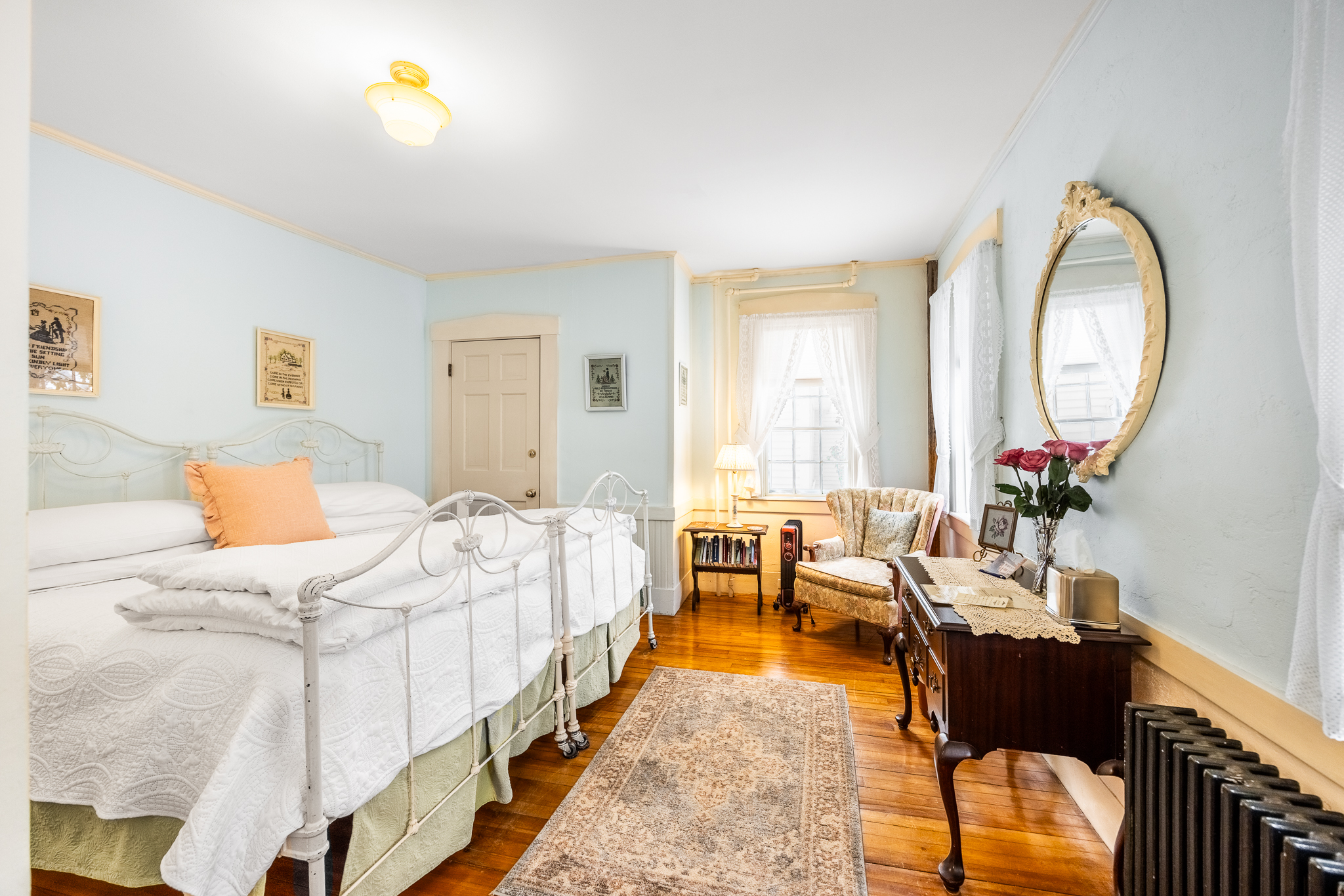 Room 1 with hardwood floors an area rug and a seating area