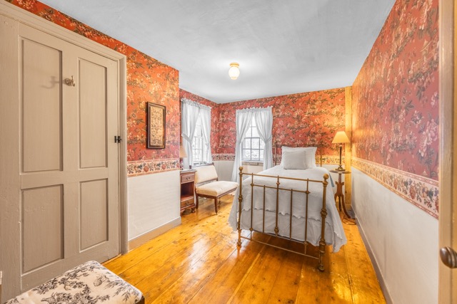 Room 2 with a twin bed and a small cushioned bench