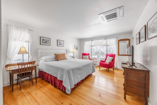 Kind size bed with desk, sitting area and dresser