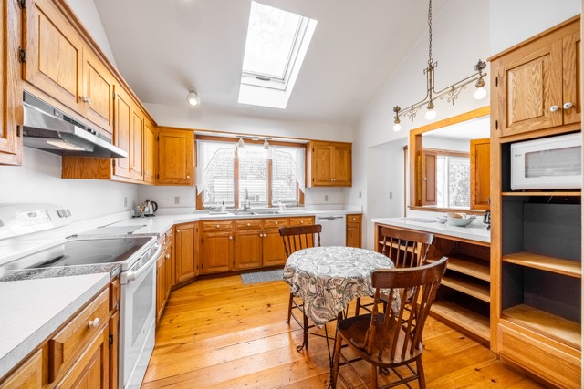 Full kitchen and a dining table in the Cape House Suite