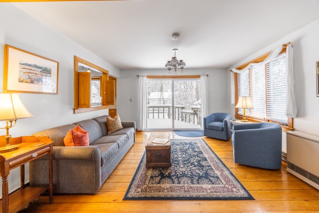 Cape House Suite living room with a sliding glass door to rear deck