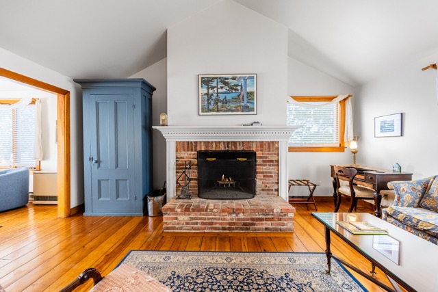 Working fireplace with seating area, desk and entertainment center